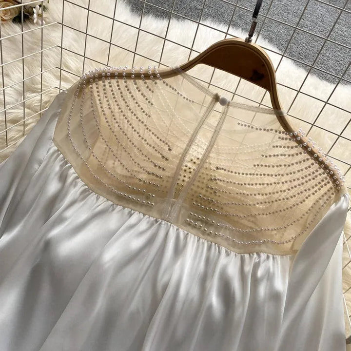 Levoire | Haut de vêtement à la conception élégante en tulle transparent et avec des volants ornés de perles